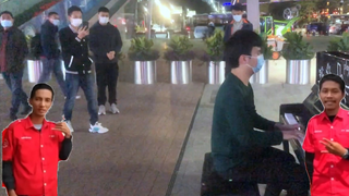 A boy playing the piano on the street