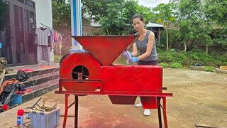 The girl repairs and restores the rice fanning machine and repaints it with a new layer of paint