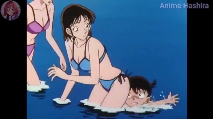 Conan was attracted to the girl in the blue swimsuit which is Ran