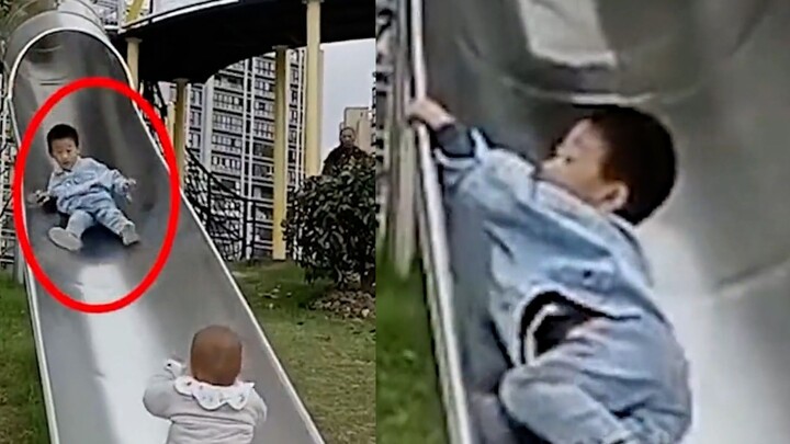 A boy suddenly encounters a baby while playing on a slide. He quickly turns around and grabs the bra