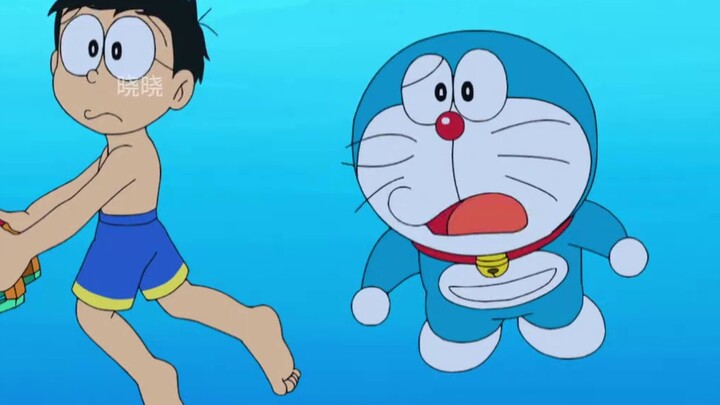 Nobita dùng mồi để điều khiển cá tới đảo hoang