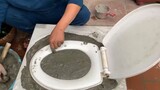 Put some cement in the middle of the toilet lid,look finished production.