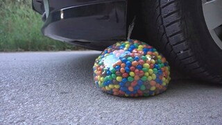 Watch a car crushing chocolate beans