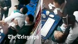Exhausted doctor collapses during check-ups as China buckles under rising Covid-19 cases