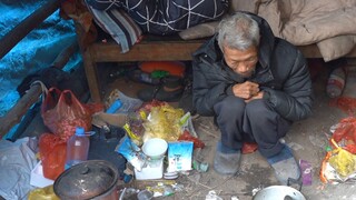 The thin grandfather is helpless. He has a concrete house but cannot live in it, so he lives in a sh