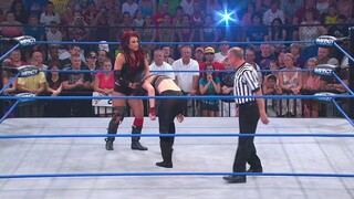 Women wrestling low blow