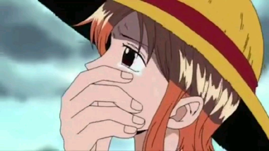 Nami crying after Luffy put his hat on her