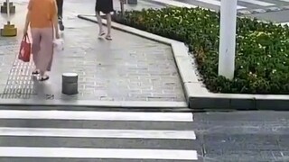 Policeman carry bag to help her in China.