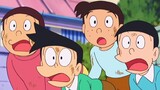 Doraemon: Nobita mengupas buah dengan alat peraga dan secara tidak sengaja meletakkannya di wajah ib