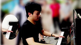 A boy covers "Bad Apple" with piano in the street