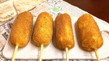 German potato dishes: Potatoes with onions and sausages on a stick