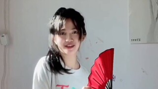 A girl dances to the moon alone at home
