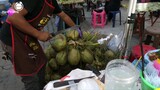 Thai Food Street - amazing skills of cutting                       and slicing of coconut