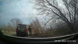 Ukrainian soldiers insult a muslim woman during a road control