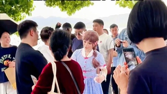 Hangzhou West Lake robot tour guide is watched by onlookers