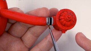 The handcraft master makes cat and mouse models with clay