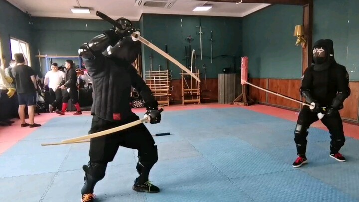 Japanese sword in right hand and Hmong sword in left hand