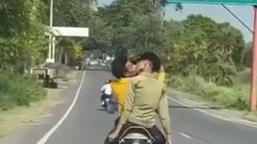 What are the two boys doing on the bike?