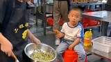 Chinese woman and her son work at restaurant in China. Her son help her, he hard work.