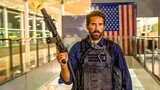 Mercenaries confront a uniformed man with a gun, unaware he's the top Navy SEAL leader