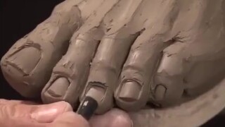 Making clay sculpture hands and feet