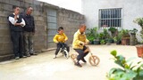 An old farmer put together a small bike using a few wooden blocks. Now his grandchildren can play with the other kids!