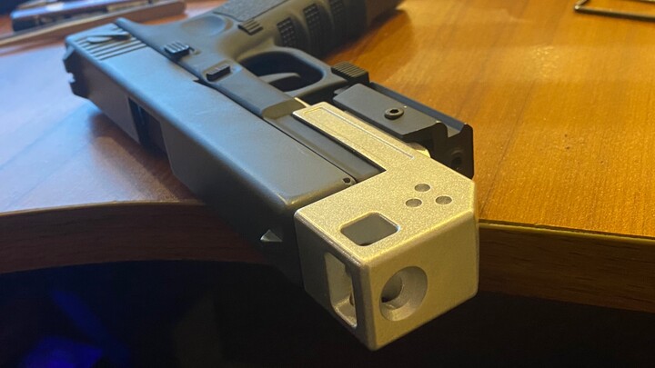 The new brake of the shell-ejecting Glock does not block the laser. It is still being modified. It c