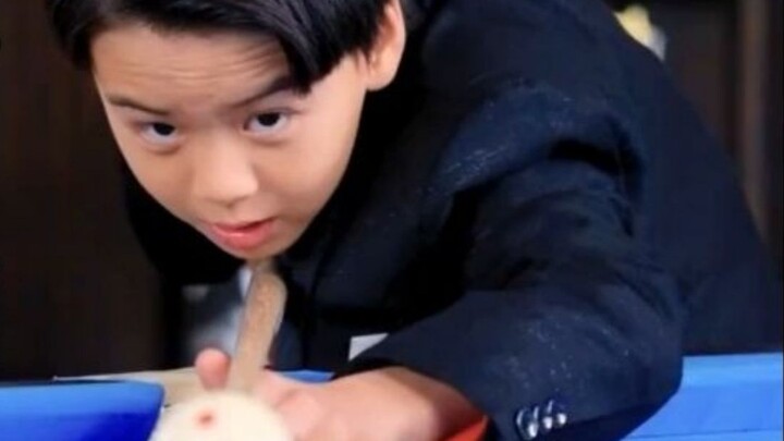 The little boy just hit the billiards, and the next second all the billiard balls went into the hole