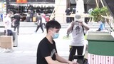Street performer playing "Steins;Gate" on the piano, filmed by the dude in white