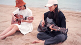 Together again! Two guitarists play I'm Yours at the seaside