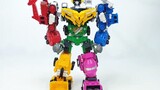 Six colorful construction vehicle toys assembled into a Hercules robot