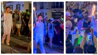 WangYibo lit up during the Olympic torch relay with the cheers of a large crowd of Parisians & fans