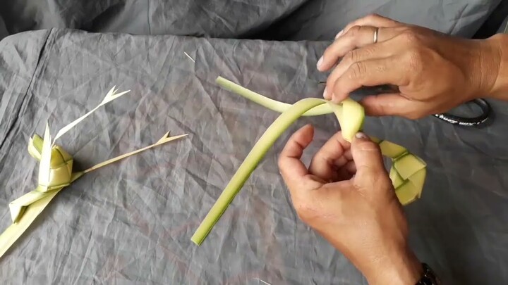 Instructions for making a toy stork with coconut leaves