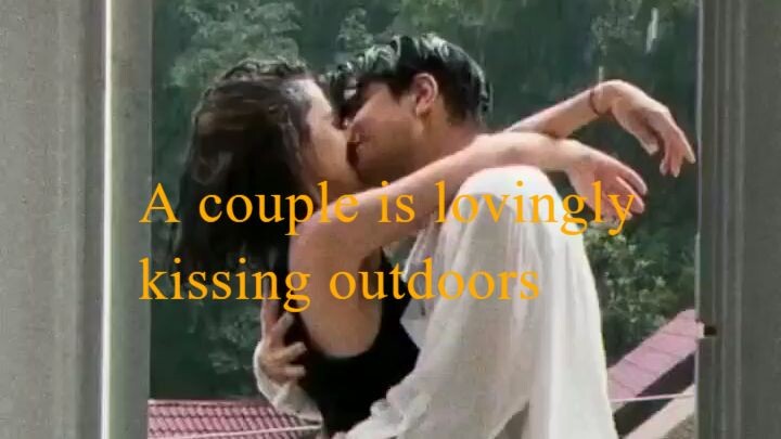 A couple is lovingly kissing outdoors