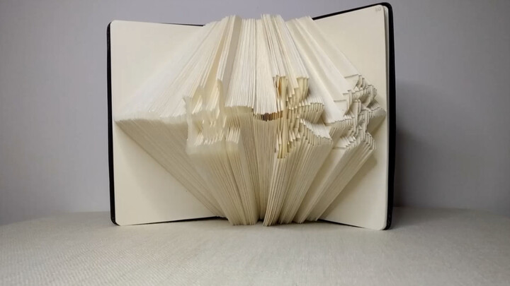 Folded "YiShiChangAn" on a book