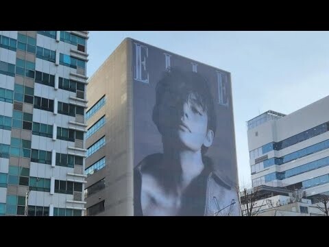 BTS's V graces an entire side of ELLE Korea's company building with his celebrated cover