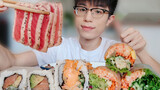 Mengunyah|sashimi ikan tuna dan sushi ikan salmon dan sushi gulung