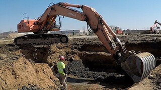 Backhoe Excavator Heavy Equipment digging footings. Time lapse. construction sight Hitachi EX450.